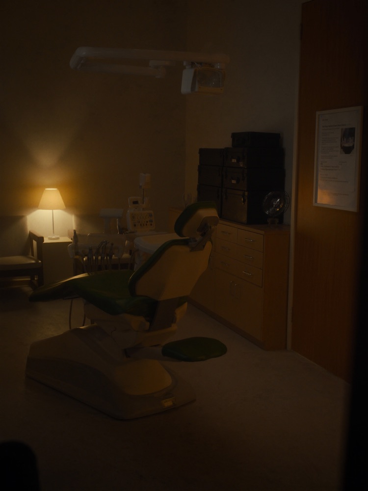 A calm dental treatment room in warm evening light